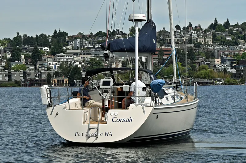 Slide: The Image of 2004 Hanse 411 sailboat "Corsair" on water near Port Orchard, WA, with cityscape backdrop. - 45