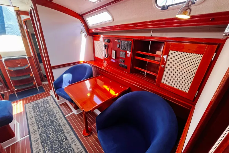Slide: The Image of Luxurious 2004 Hanse 411 yacht interior with elegant wood finish and plush blue seating. - 6