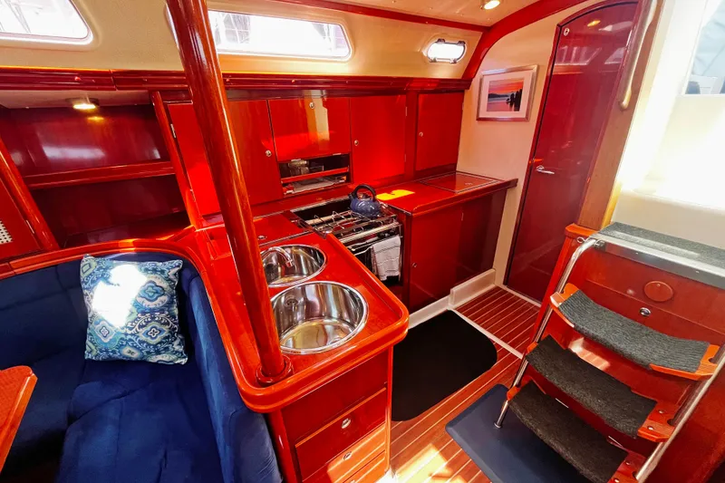 Slide: The Image of Luxurious 2004 Hanse 411 yacht interior with polished wood, dual sinks, and cozy seating. - 8