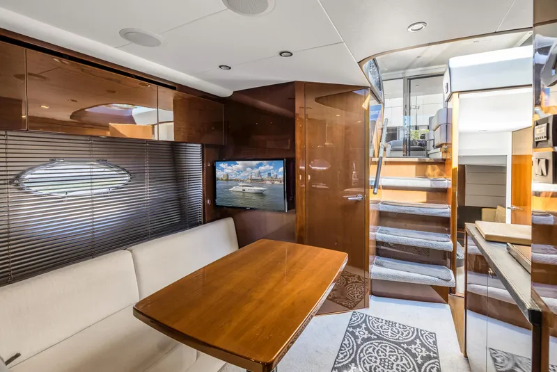 Slide: The Image of Interior of a 2013 Princess V57 yacht with wooden table and stairs. - 13