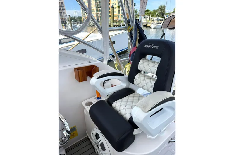 Slide: The Image of Captain's chair on 2006 Pro-Line 32 Express boat, docked at marina. - 11