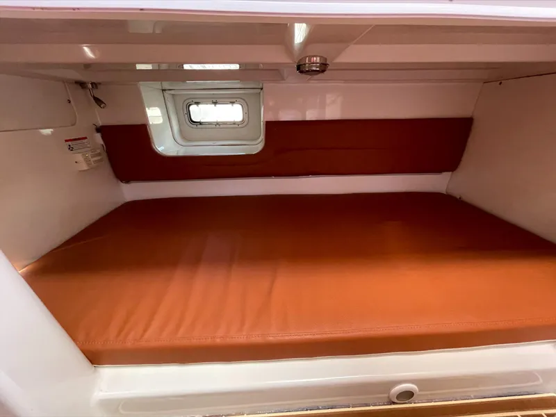 Slide: The Image of Interior of a Pro-Line 32 Express with brown upholstery and a small window. - 15