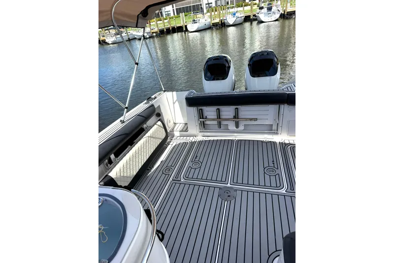 Slide: The Image of 2006 Pro-Line 32 Express boat deck with twin engines, docked at marina. - 23