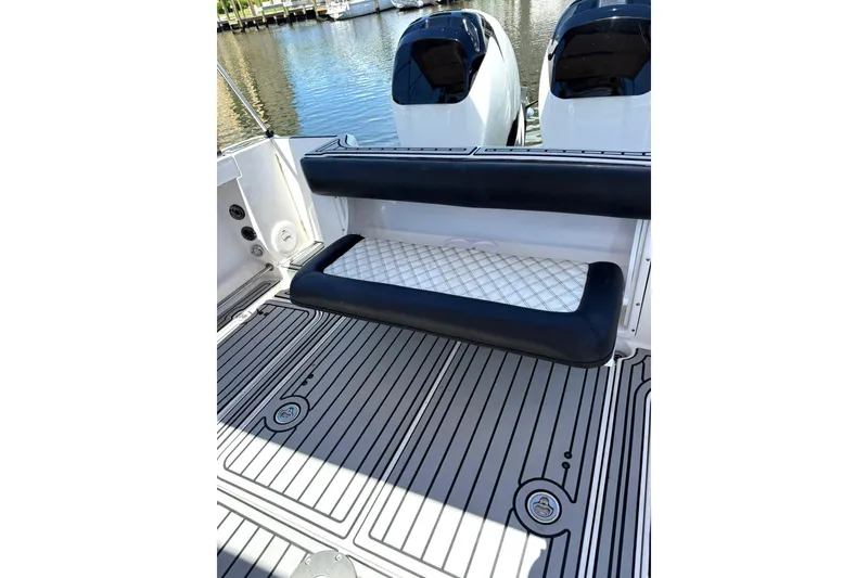 Slide: The Image of 2006 Pro-Line 32 Express boat with cushioned seating and twin engines, docked by the water. - 24