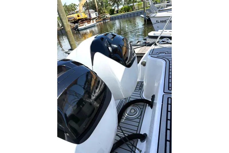 Slide: The Image of 2006 Pro-Line 32 Express boat engines docked by the water. - 25