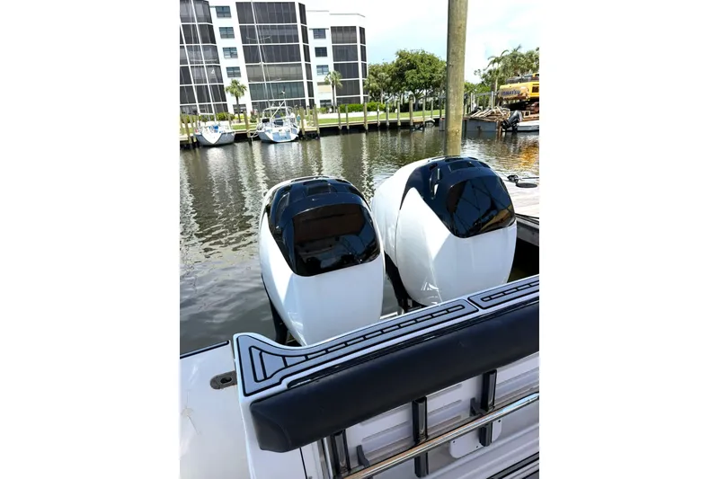 Slide: The Image of 2006 Pro-Line 32 Express boat with dual outboard engines docked in marina. - 26