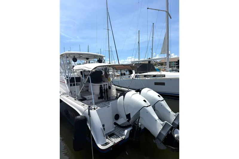 Slide: The Image of 2006 Pro-Line 32 Express boat docked with dual outboard engines. - 27