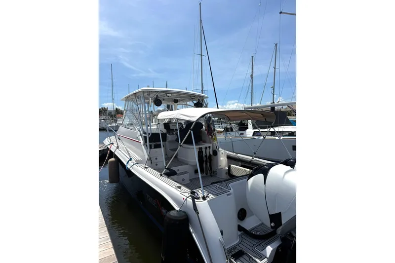 Slide: The Image of 2006 Pro-Line 32 Express boat docked at marina under clear blue sky. - 29