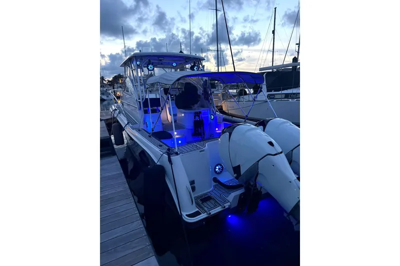 Slide: The Image of 2006 Pro-Line 32 Express boat docked at sunset with blue LED lights. - 30