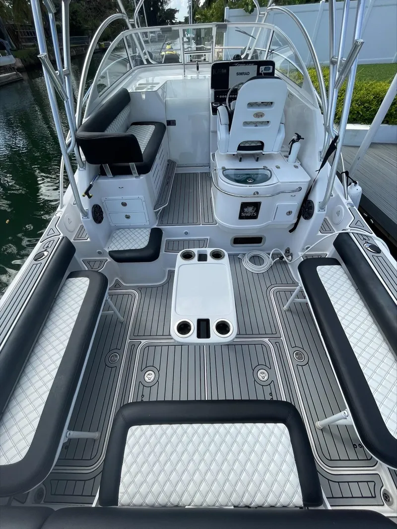 Slide: The Image of The boat features a spacious deck with seating benches and a helm station. - 7
