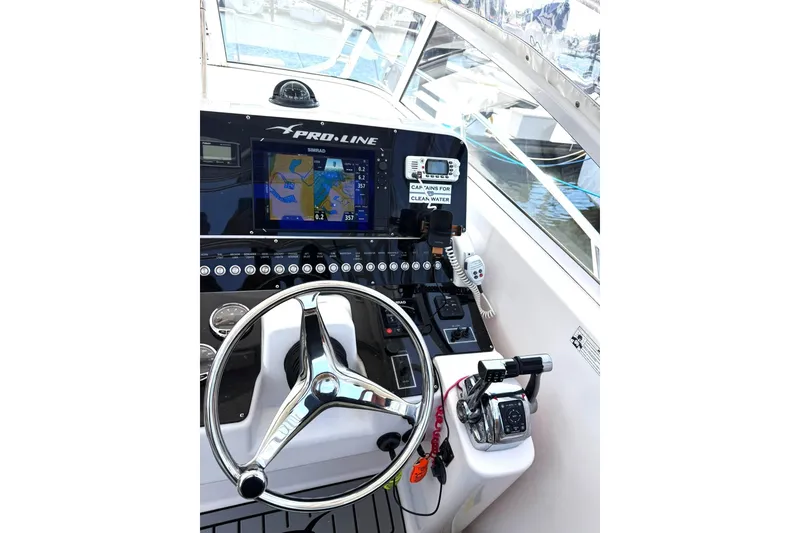 Slide: The Image of 2006 Pro-Line 32 Express boat helm with navigation system and steering wheel. - 8