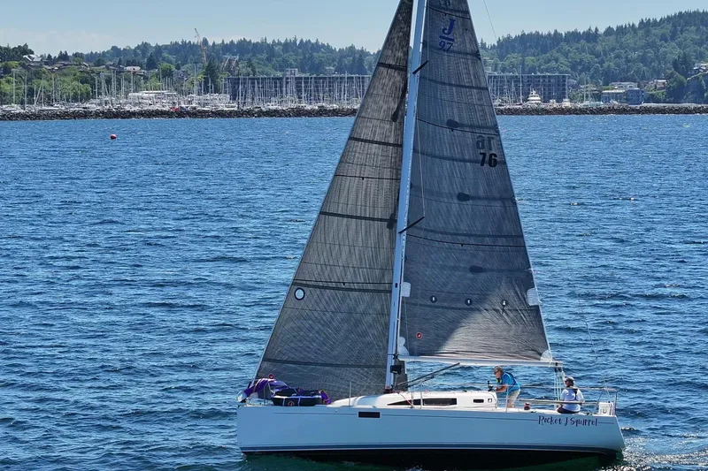 Slide: The Image of 2018 J Boats J/97E sailing on a sunny day with scenic shoreline backdrop. - 2