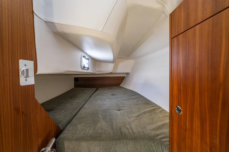 Slide: The Image of Interior cabin of 2018 J Boats J/97E, featuring cozy sleeping area and wooden cabinetry. - 15