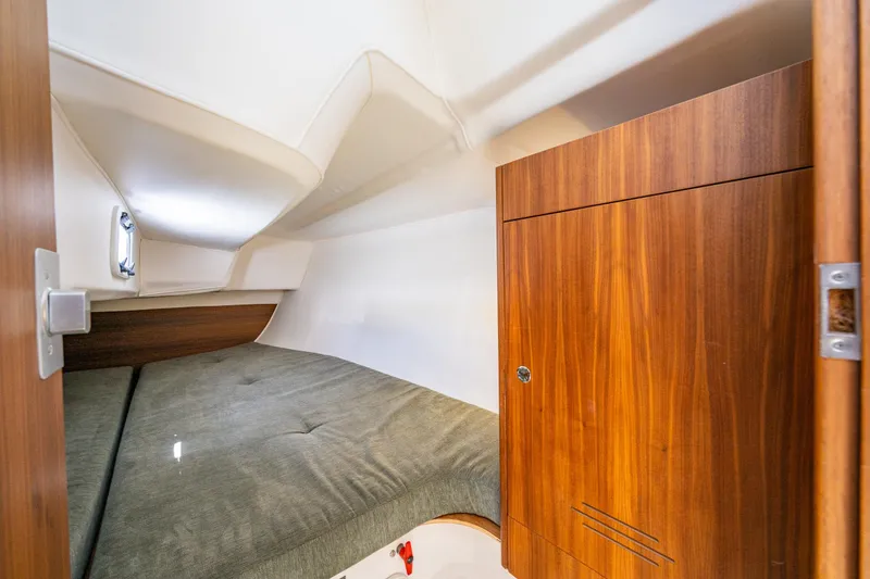 Slide: The Image of 2018 J Boats J/97E cabin interior with wooden cabinetry and cozy sleeping area. - 14