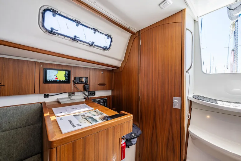 Slide: The Image of Interior of 2018 J Boats J/97E sailboat with navigation equipment and wooden cabinetry. - 11