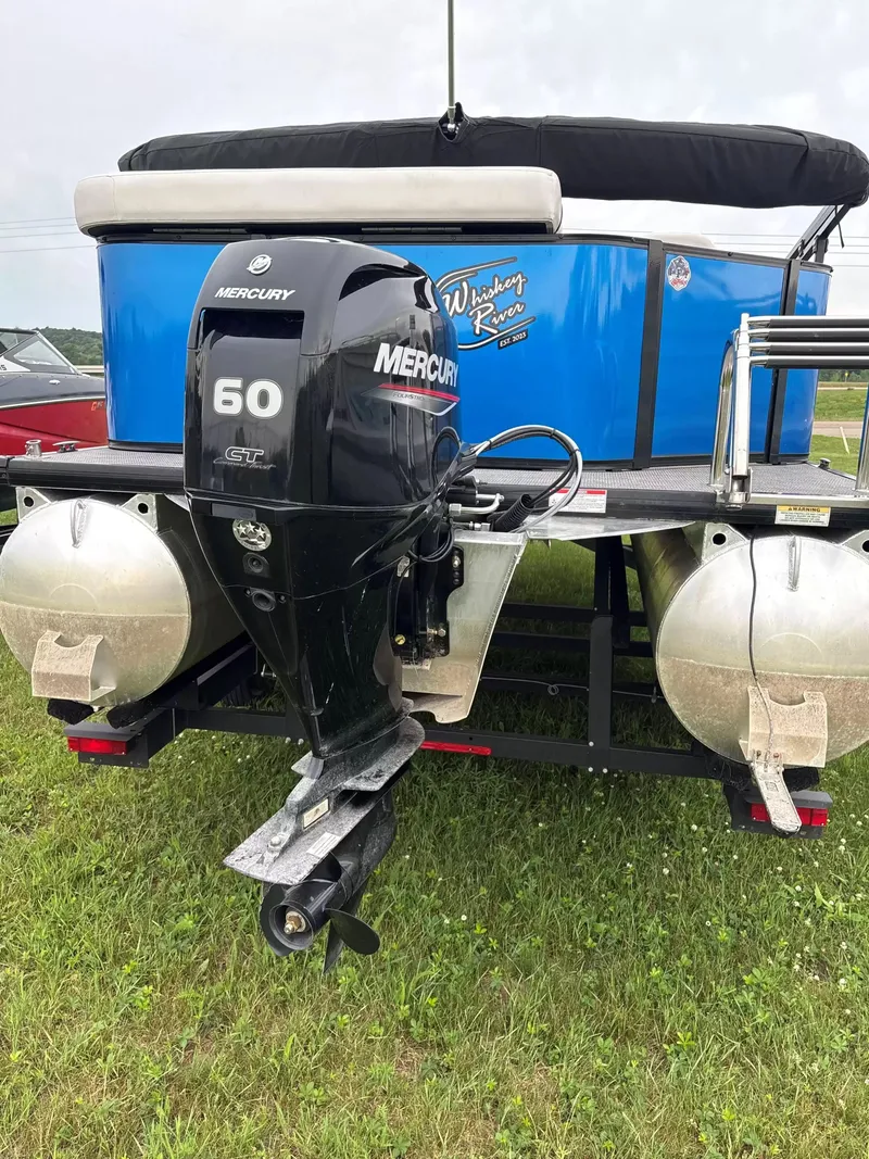 Slide: The Image of Rear view of a blue Viaggio L20C pontoon boat with a Mercury 60 HP outboard motor. - 8
