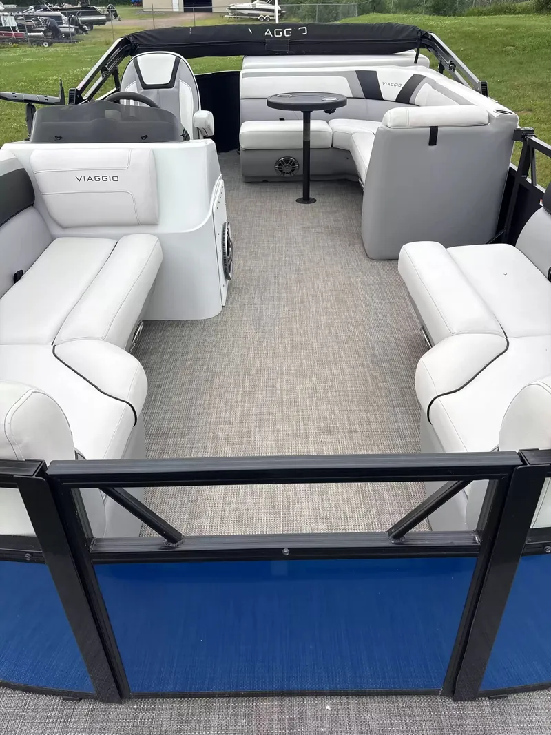 Slide: The Image of Interior of a Viaggio L20C pontoon boat with white seating and gray flooring. - 3