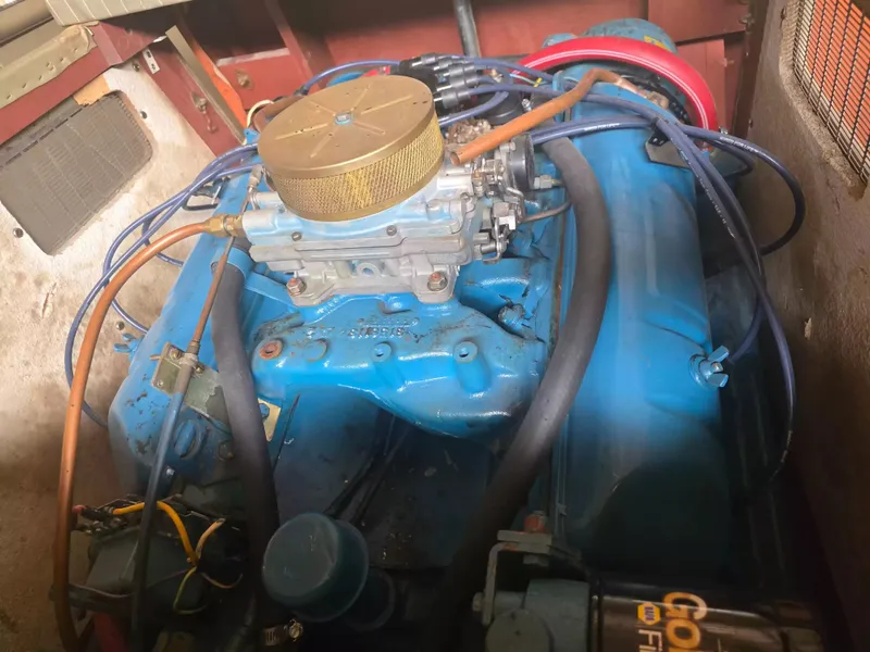 Slide: The Image of A blue engine in a boat, with visible wiring and a gold air filter. - 9