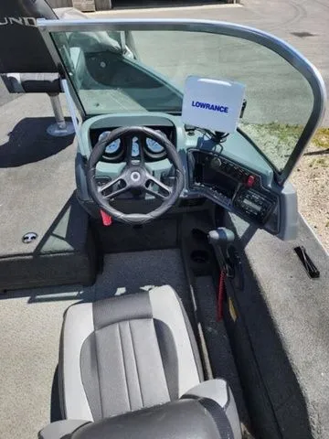 Slide: The Image of Interior of 2014 Lund Impact 1875 boat with steering wheel and Lowrance device. - 5