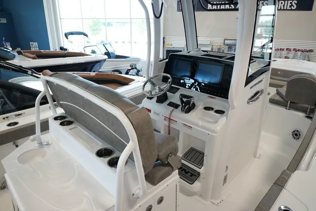 Slide: The Image of The image shows the cockpit of a 2027 Sea Hunt Ultra 265SE boat with modern features. - 26