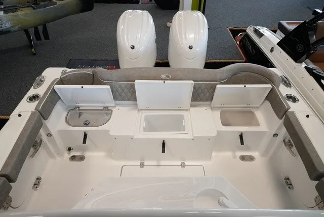 Slide: The Image of The image shows the cockpit of a Sea Hunt Ultra 265SE boat with gray upholstery. - 12