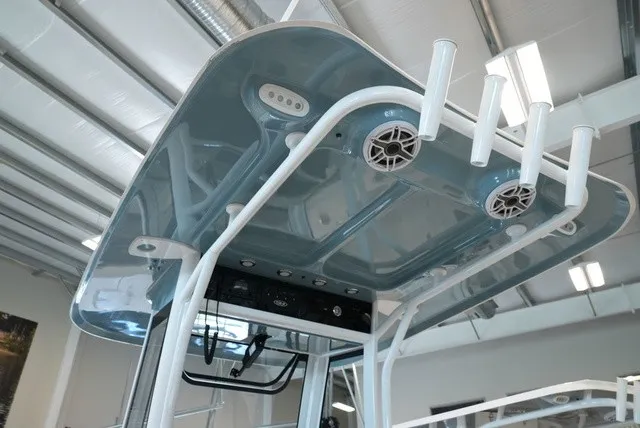 Slide: The Image of The image shows the hardtop of a Sea Hunt Ultra 265SE boat with speakers and rod holders. - 27
