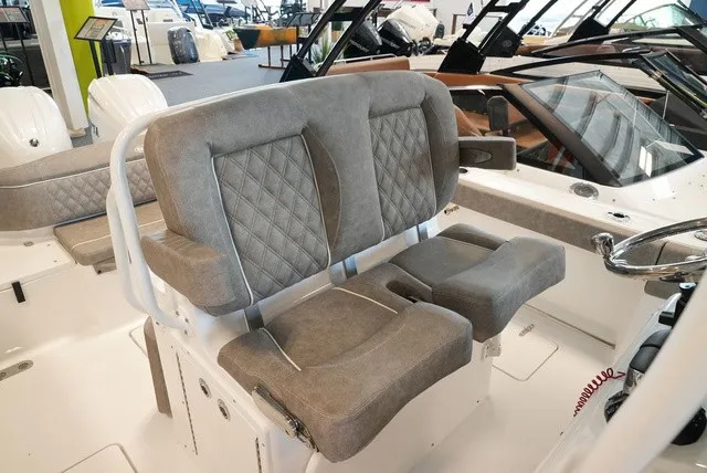 Slide: The Image of The 2027 Sea Hunt Ultra 265SE features a luxurious, cushioned bench seat with a quilted design. - 29