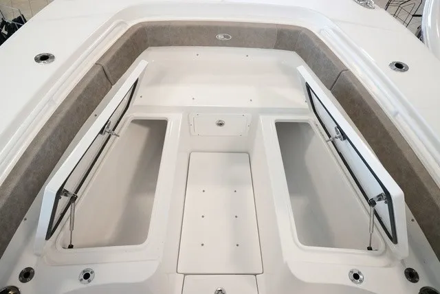 Slide: The Image of The image shows the bow area of a Sea Hunt Ultra 265SE boat with open storage compartments. - 44