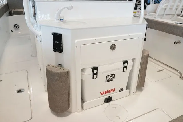 Slide: The Image of The image shows the cockpit of a Sea Hunt Ultra 265SE with a built-in cooler and sink. - 17