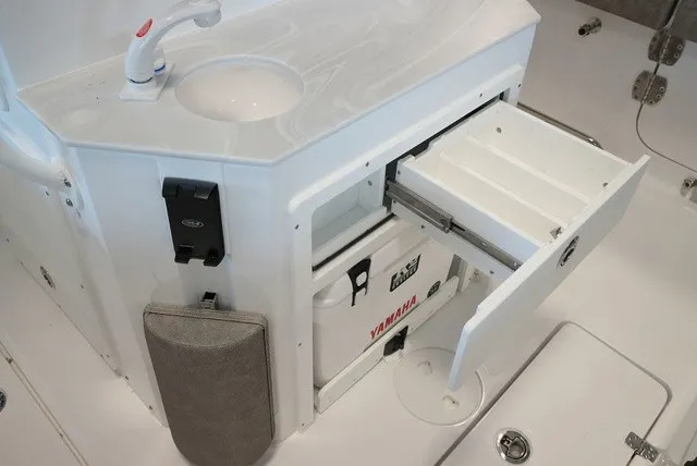 Slide: The Image of A sleek white boat galley module with a sink, faucet, and storage compartments. - 19