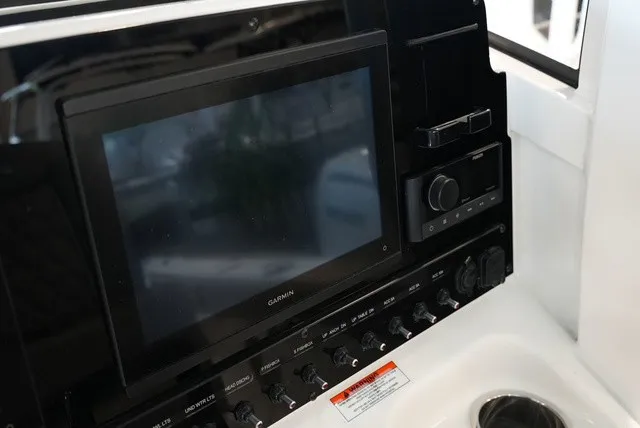 Slide: The Image of The image shows the dashboard of a Sea Hunt Ultra 265SE boat with a Garmin screen. - 38