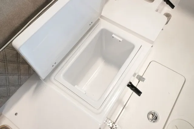 Slide: The Image of Open storage compartment on a 2027 Sea Hunt Ultra 265SE boat. - 14