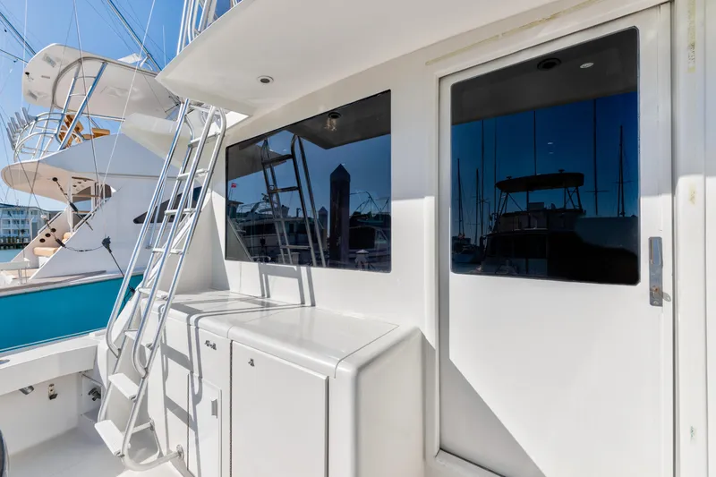 Slide: The Image of 1999 Viking 47 Convertible yacht exterior with ladder and storage compartments. - 14