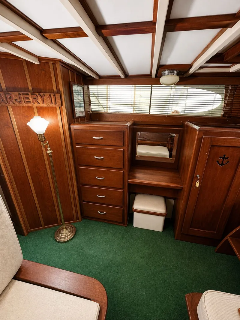 Slide: The Image of Interior of a 1951 Chris-Craft 50 Catalina yacht, featuring wood furniture and green carpet. - 12