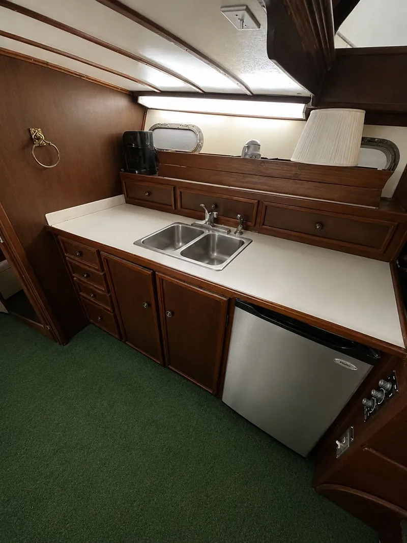Slide: The Image of Interior of 1951 Chris-Craft 50 Catalina yacht, featuring kitchen and sink. - 23