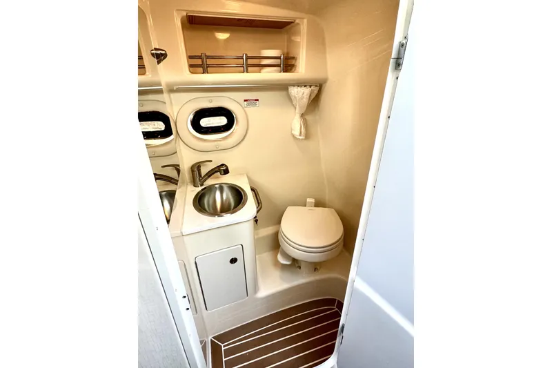 Slide: The Image of Compact bathroom in 2018 Sea Ray Sundancer 260 boat with sink and toilet. - 10