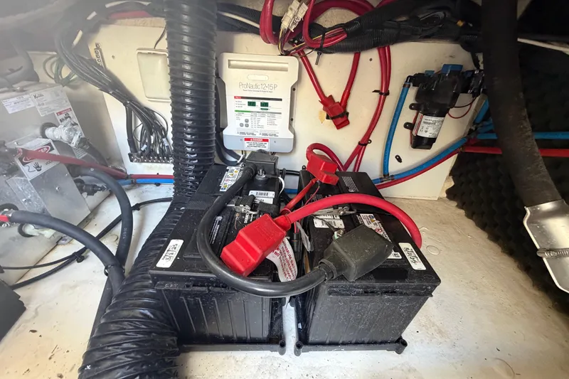 Slide: The Image of Engine compartment of 2018 Sea Ray Sundancer 260 with batteries and wiring. - 101