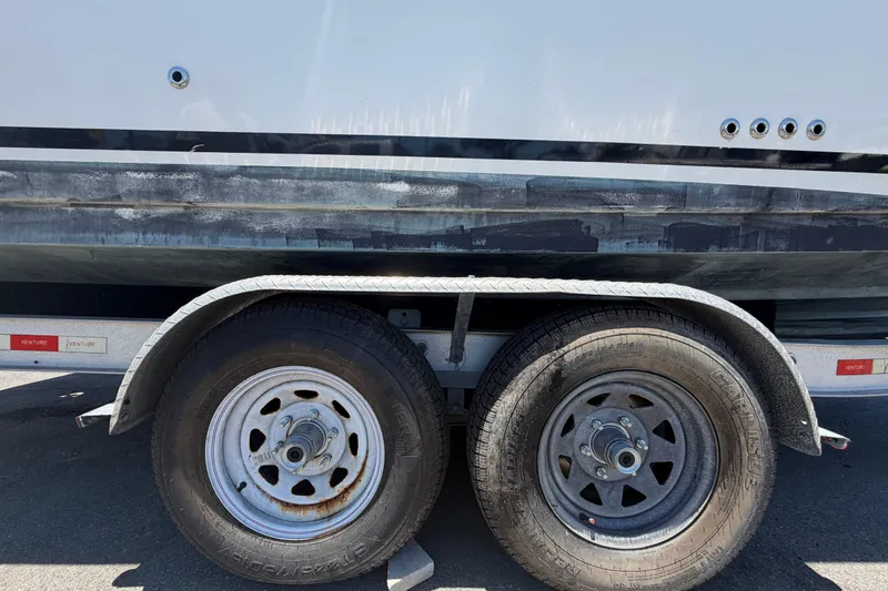 Slide: The Image of Trailer wheels supporting a 2018 Sea Ray Sundancer 260 boat. - 105