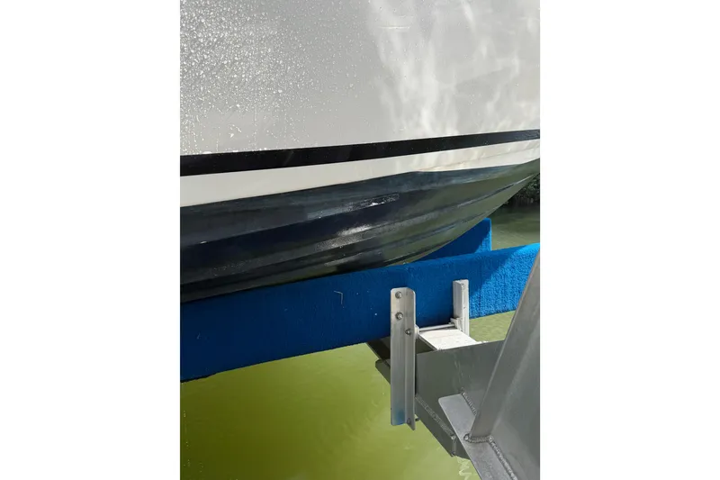 Slide: The Image of Close-up of 2018 Sea Ray Sundancer 260 hull on a boat lift. - 15