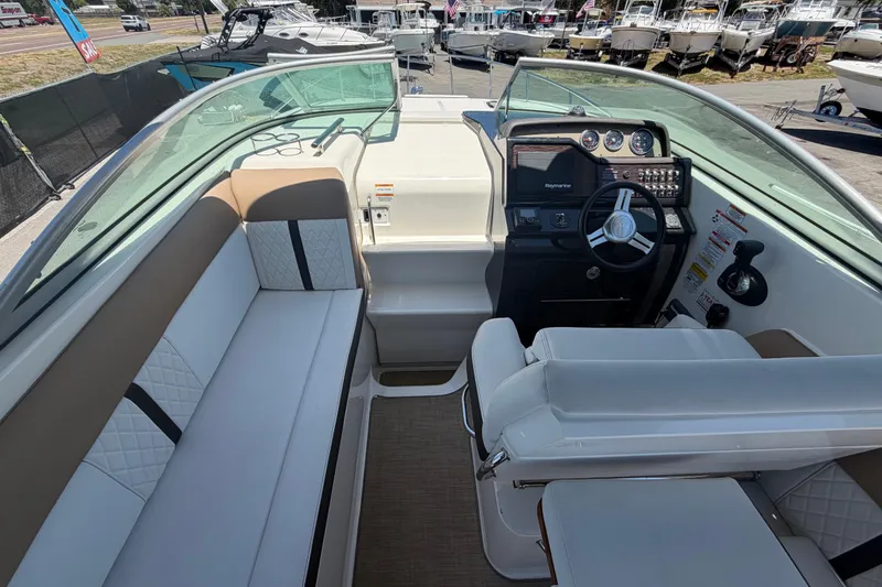 Slide: The Image of 2018 Sea Ray Sundancer 260 cockpit with seating and helm, showcasing modern design. - 17