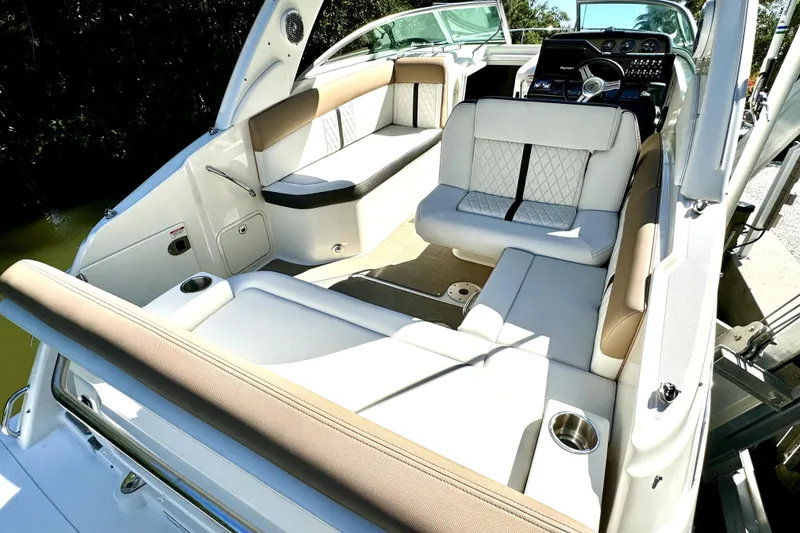 Slide: The Image of Interior of 2018 Sea Ray Sundancer 260 boat with luxurious seating and modern dashboard. - 2