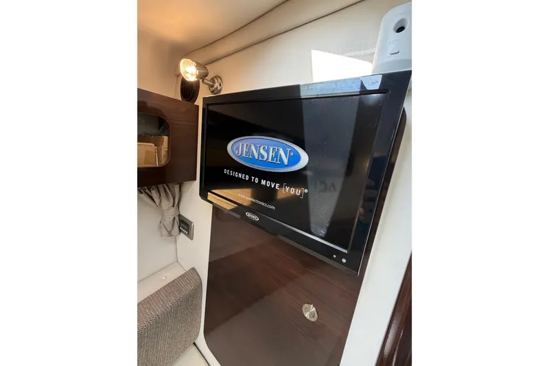 Slide: The Image of Jensen TV inside 2018 Sea Ray Sundancer 260 cabin, showcasing modern interior design. - 24