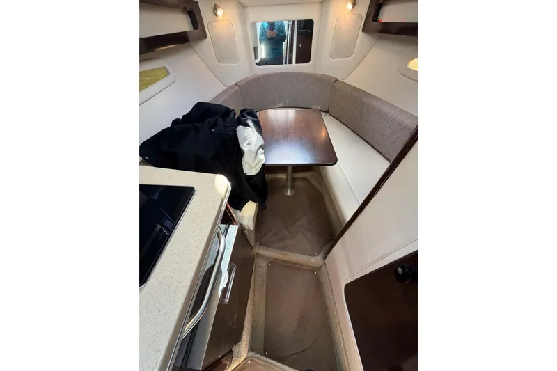 Slide: The Image of 2018 Sea Ray Sundancer 260 cabin interior with seating and table. - 31