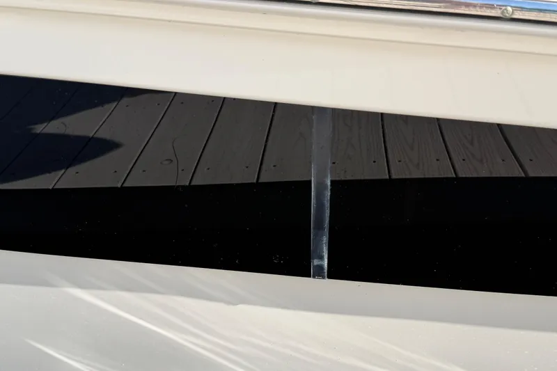 Slide: The Image of Close-up of a 2018 Sea Ray Sundancer 260 boat hull with dock reflection. - 36