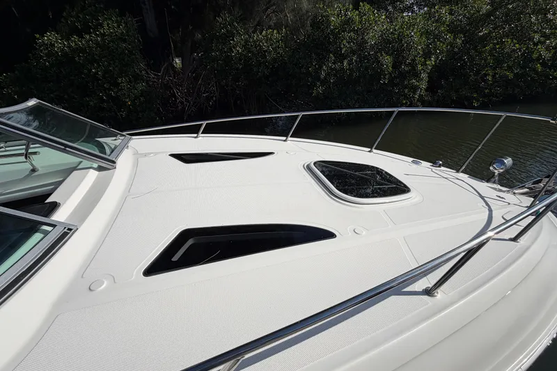 Slide: The Image of 2018 Sea Ray Sundancer 260 boat deck with sleek design and open hatch. - 37