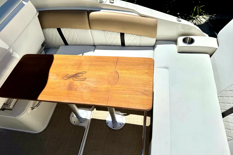 Slide: The Image of Interior seating area of a 2018 Sea Ray Sundancer 260 with a wooden table. - 4
