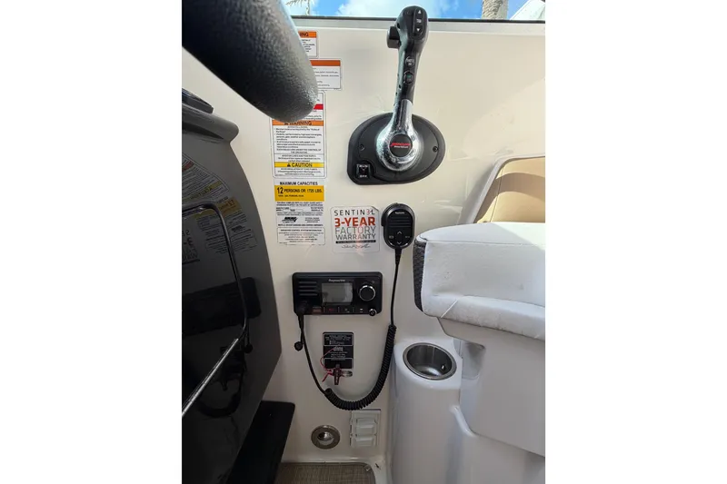 Slide: The Image of 2018 Sea Ray Sundancer 260 cockpit controls with warranty and capacity labels. - 45