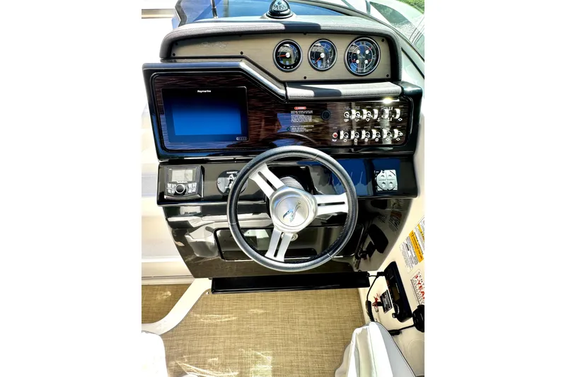 Slide: The Image of Cockpit of 2018 Sea Ray Sundancer 260 with steering wheel and control panel. - 5