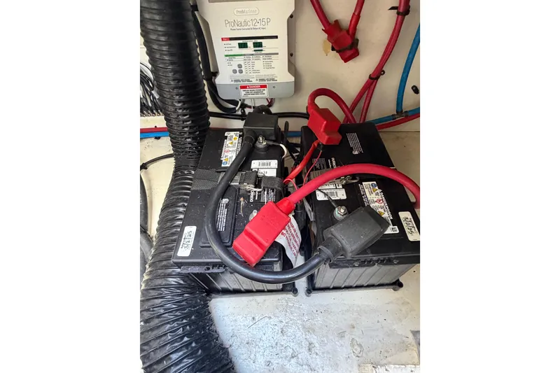 Slide: The Image of Battery compartment of 2018 Sea Ray Sundancer 260 with ProNautic charger and cables. - 50