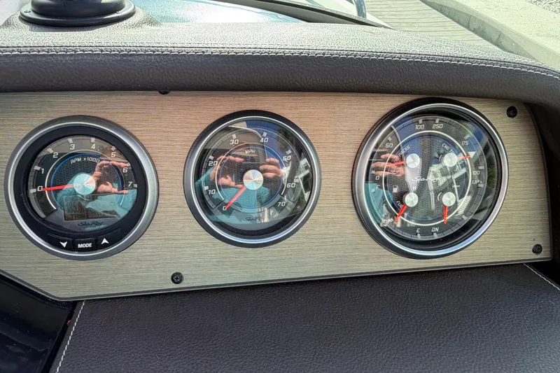 Slide: The Image of Dashboard gauges of a 2018 Sea Ray Sundancer 260 boat, displaying RPM and speed. - 53